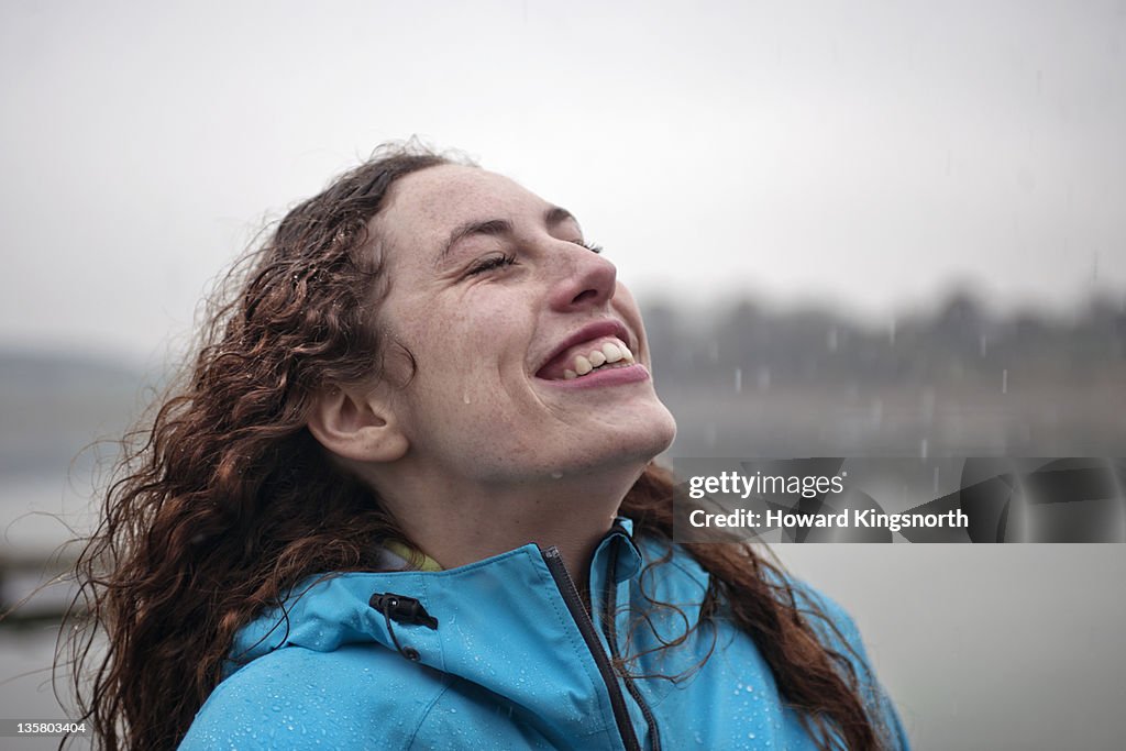 Portrait of female enjoying rain