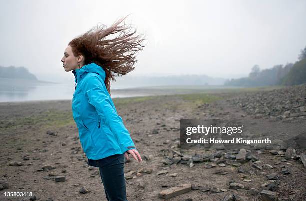 female leaning into wind with hair flying - composition stock pictures, royalty-free photos & images