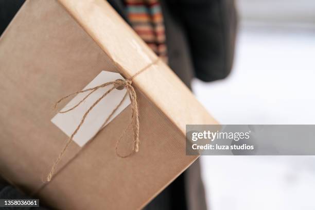 a christmas gift under his arm - wrapping arm stock pictures, royalty-free photos & images