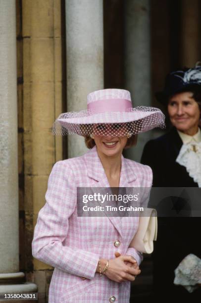 British Royal Diana, Princess of Wales , wearing a pink-and-white checked coatdress with a matching wide-brim hat with a pink bow and white veil,...