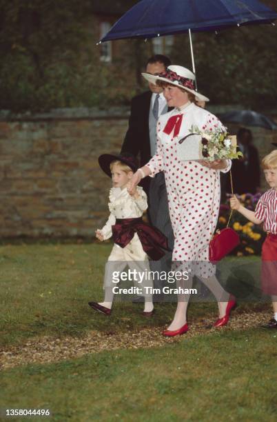 Lady Sarah McCorquodale, sister of Princess Diana, holding the hand of her nephew Prince Harry at the wedding of Charles Spencer, 9th Earl Spencer...