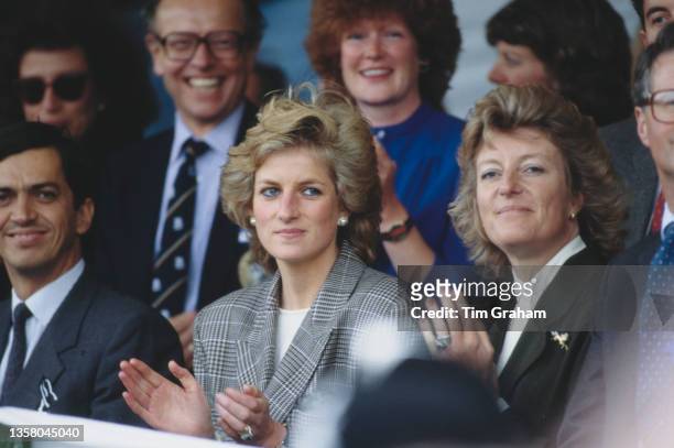 Diana, Princess of Wales wearing a Glen Plaid blazer, with her sister, Lady Sarah McCorquodale, sitting behind among spectators at Burghley Horse...