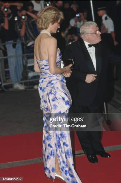 British Royal Diana, Princess of Wales , wearing a strapless pale pink-and-blue Catherine Walker evening gown, attends the Royal Premiere of 'When...