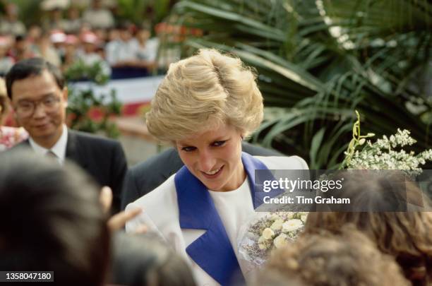 British Royal Diana, Princess of Wales , wearing a blue-and-white Catherine Walker suit and a Remembrance poppy, greeting well-wishers during a visit...