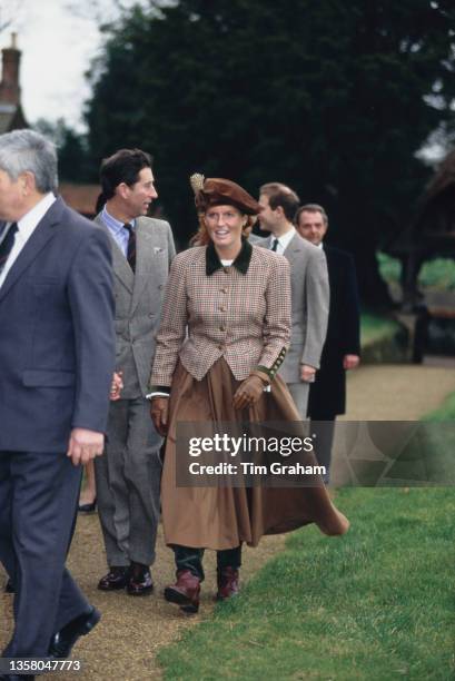 British Royals Charles, Prince of Wales and Sarah, Duchess of York, wearing a tweed jacket with a black collar, a long brown skirt, and a Tudor-style...