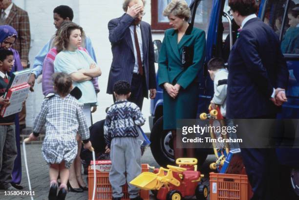 British Royal Diana, Princess of Wales , wearing a green suit with a black collar on the jacket, meeting children during a visit to the Thomas Coram...