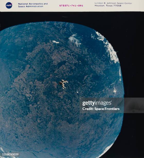 Wide angle view of the Russian space station Mir against a backdrop of Mato Grosso in the Central-West region of Brazil, as seen from the Space...