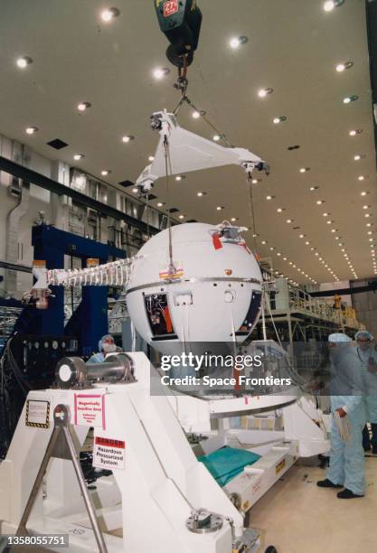 John Powell and Jim Nail of McDonnell Douglas Space and Defense Systems prepare the satellite element of the Tethered Satellite System-1R for...