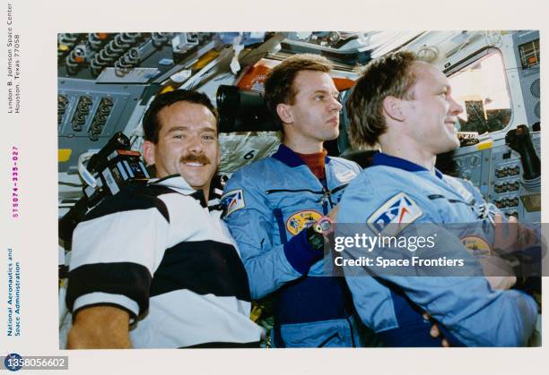 Canadian CSA astronaut Chris Hadfield, Ukrainian-born Russian cosmonaut Yuri Gidzenko, and Russian cosmonaut Sergey Avdeev inspect the Russian Space...