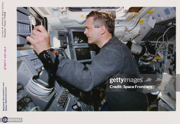 Canadian CSA Marc Garneau controls the Remote Manipulator System on the aft flight deck of Space Shuttle Endeavour mission STS-77, 19th to 29th May...