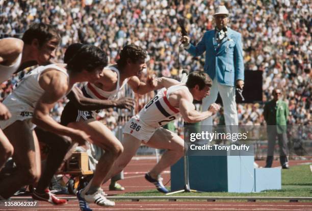 An Olympic official fires the starting gun as Brian Green of Great Britain comes off the blocks at the start of Heat 4 of the Men's 100 metres event...