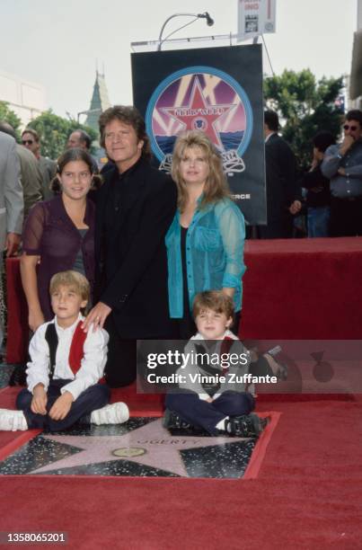 American singer, songwriter and musician John Fogerty, his wife Julie, their twin sons, Shane and Tyler, and Julie's daughter Lyndsay attend...