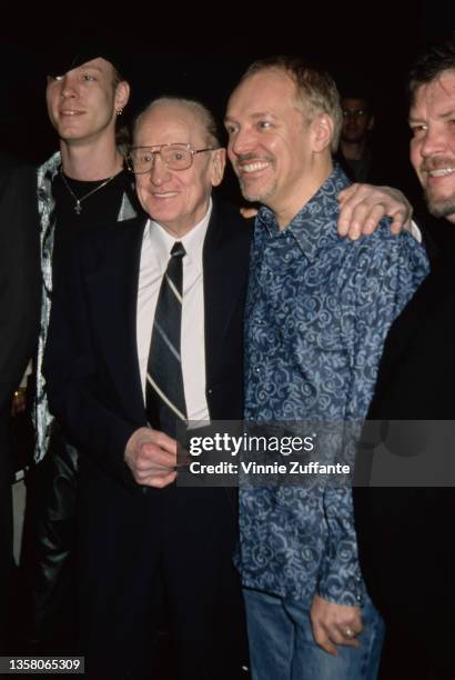 American guitarist, songwriter, and luthier Les Paul with his arm around the shoulder of British singer, songwriter and guitarist Peter Frampton at...