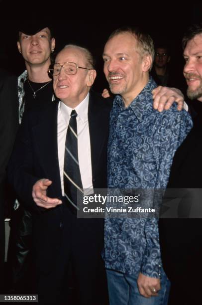 American guitarist, songwriter, and luthier Les Paul with his arm around the shoulder of British singer, songwriter and guitarist Peter Frampton at...