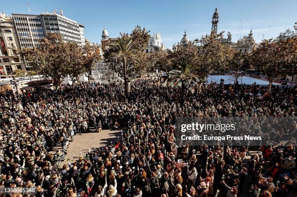 Crowd holds white flowers at a rally and minute of silence in memory of Cristina, a woman victim of gender violence, in the Plaza del Ayuntamiento,...