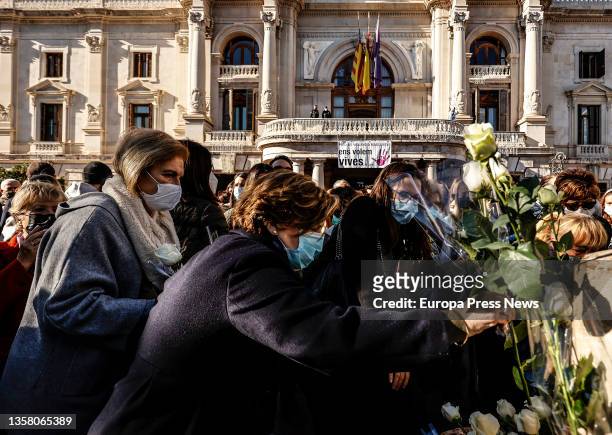 Several people lay white flowers at a rally and minute of silence in memory of Cristina, a woman victim of gender violence, in the Plaza del...