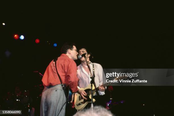 American singer-songwriter Marshall Crenshaw performing alongside American singer-songwriter Steve Forbert live in concert, circa 1985.