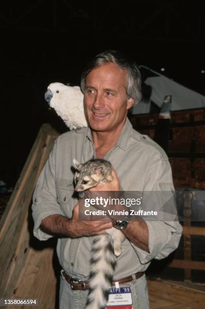 American zookeeper Jack Hanna holding a lemur with a tropical bird on his shoulder attends the 36th Annual National Association of Television Program...