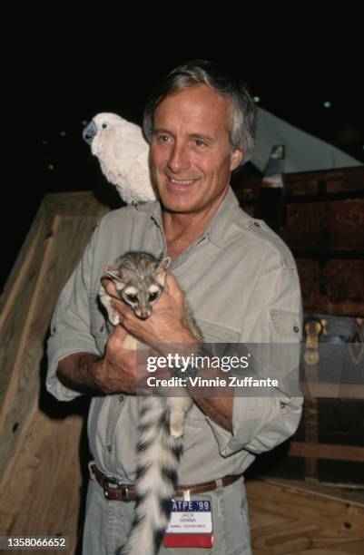 American zookeeper Jack Hanna holding a lemur with a tropical bird on his shoulder attends the 36th Annual National Association of Television Program...