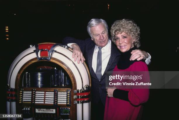 American actor Eddie Albert and American actress, comedian and singer Betty Hutton pose beside a jukebox as they attend a rehearsal for 'Jukebox...