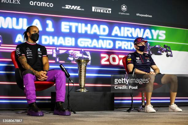 Lewis Hamilton of Great Britain and Mercedes GP and Max Verstappen of Netherlands and Red Bull Racing talk in the Drivers Press Conference during...