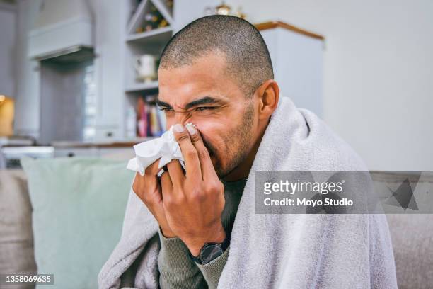 shot of a young man blowing his nose during a cold - covering nose stock pictures, royalty-free photos & images