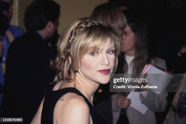 American singer, songwriter and actress Courtney Love wearing a leopard print headband attends David Bowie's 50th Birthday Celebration Concert, held...