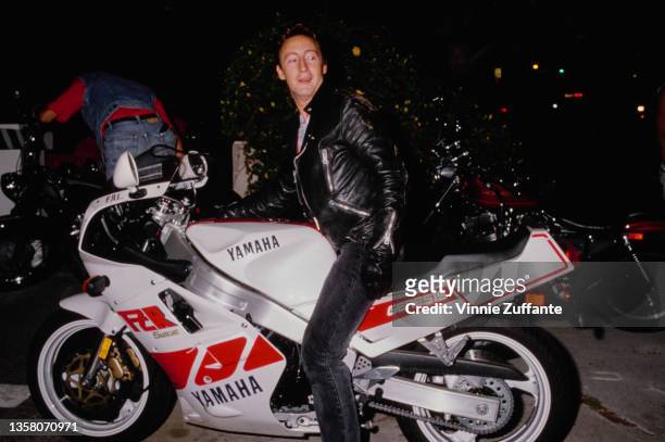British singer, songwriter and photographer Julian Lennon, wearing a black leather jacket with a Yamaha motorcycle, attends the El Rescate Benefit...