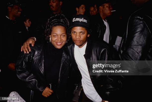 American R&B singer Michel'le , wearing a black leather jacket, with American rapper Eazy-E , wearing a black leather jacket and a Compton baseball...