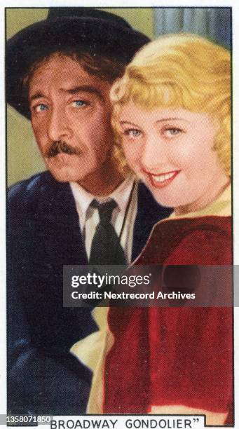 Collectible tobacco or cigarette card, 'Shots from Famous Films' series, published in 1936 by Gallaher Ltd, here actors Adolphe Menjou and Joan...