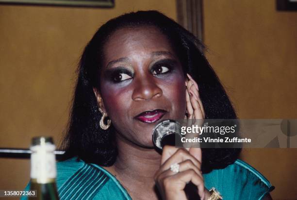 American singer and actress Patti LaBelle speaks into a microphone at an event, held at Sardi's Restaurant in New York City, New York, 1982.
