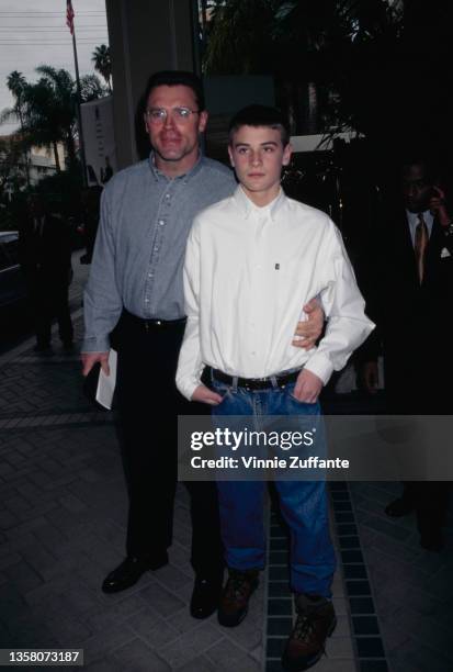 American football player and actor Howie Long with his arm around his son Chris attending an event, circa 1997.