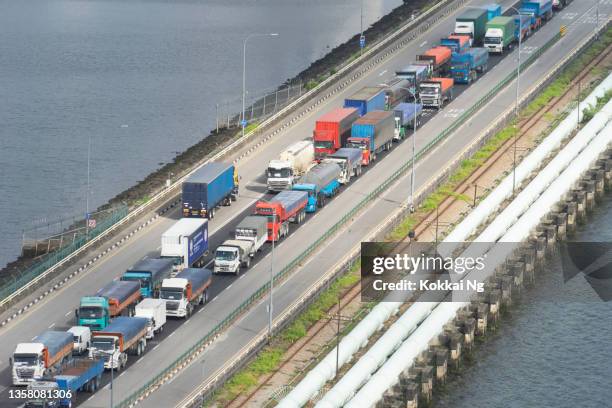 trucks queueing on the johor-singapore causeway - johor stock pictures, royalty-free photos & images