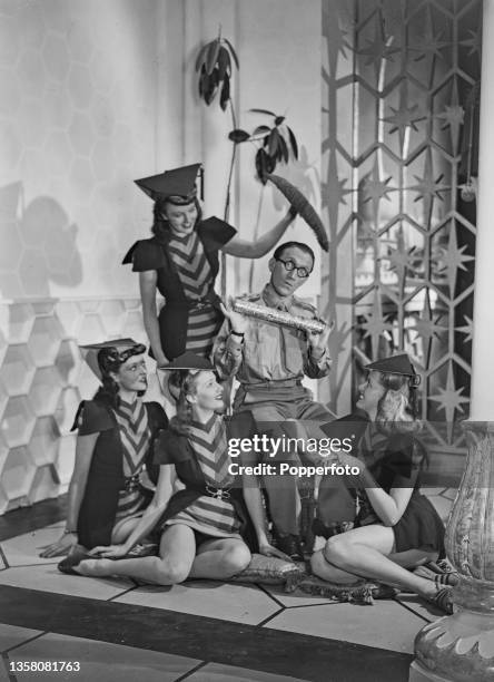 English comedian and actor Arthur Askey posed in centre with, from left, Virginia Keiley, Sheila Bligh , Una Sheppard and Iris Lang on set during...