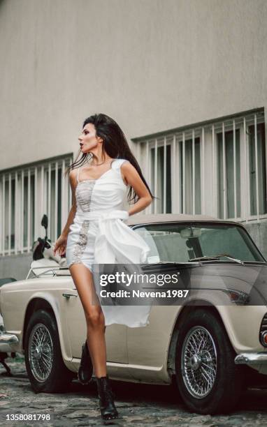 beautiful young bride near to classic car - bride running stock pictures, royalty-free photos & images