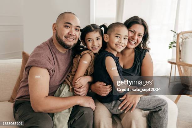 vaccination for the family and kids - asian latino kids stock pictures, royalty-free photos & images