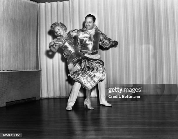 Dancers Lucy and Tony, in matching costumes, perform the Cha-Cha-Cha. It is a jazzy version of the Mambo with a triple beat.