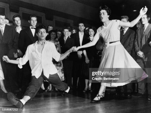 Teenagers getting down to serious business in a rock'n roll session in a London ballroom.