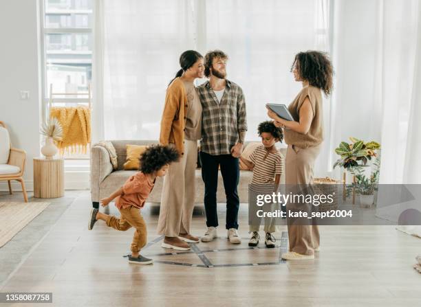 family visiting new home with real estate agent and kids - real estate agents stock pictures, royalty-free photos & images
