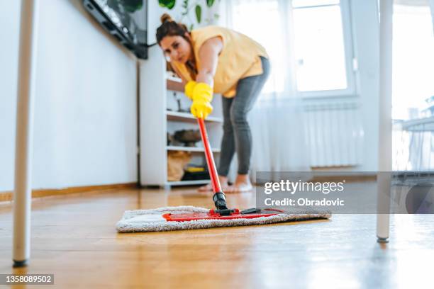 barefoot woman cleaning floor with wet mop pad - mop stock pictures, royalty-free photos & images