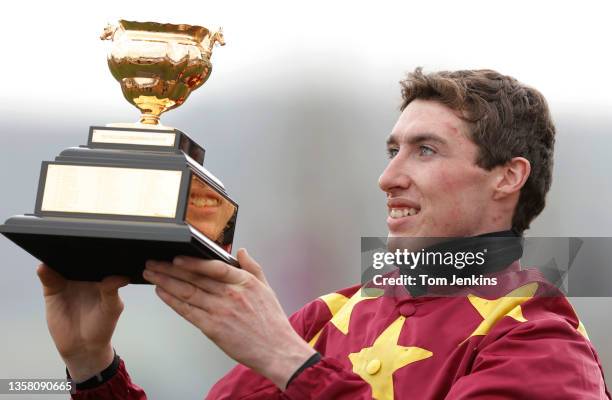 Jack Kennedy celebrates with the trophy after winning the Gold Cup on board Minella Indo during day four of the Cheltenham National Hunt Racing...