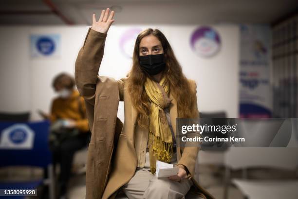 woman sitting in waiting area at a vaccination center - long form stock pictures, royalty-free photos & images