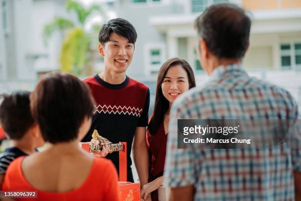 asiatisches chinesisches lächelndes paar besucht eltern während des chinesischen neujahrsfestes - 39 year old stock-fotos und bilder