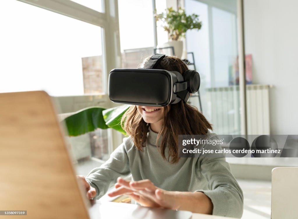 Pretty teenage girl playing with virtual reality glasses