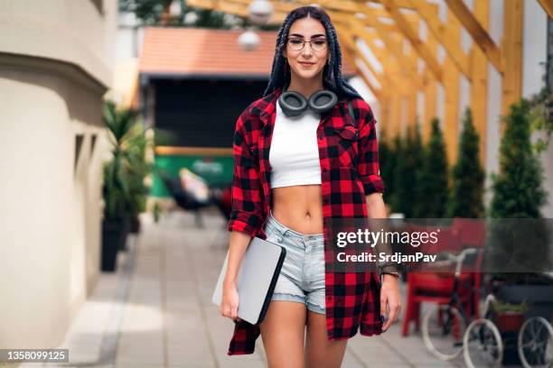 portrait of confident young hipster woman, holding laptop - crop top stock pictures, royalty-free photos & images