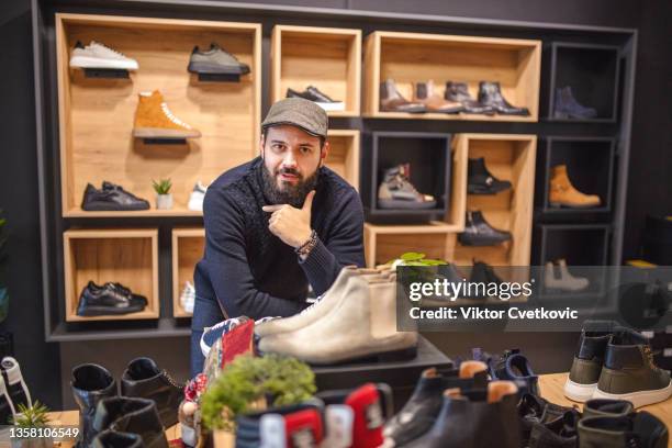 portrait of a male owner in his shoe store - shoe seller imagens e fotografias de stock