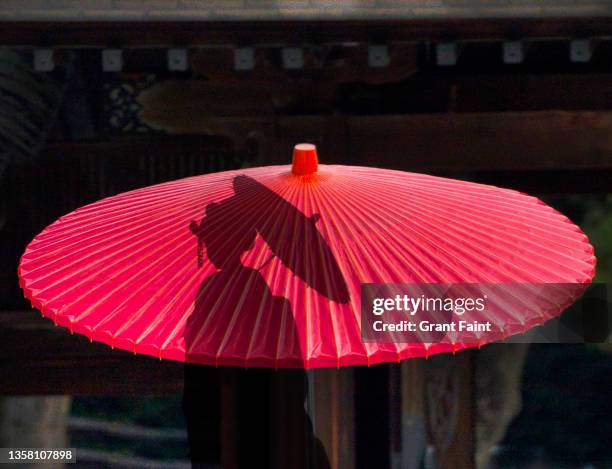 composite image, geisha with umbrellas - 明治神宮 ストックフォトと画像
