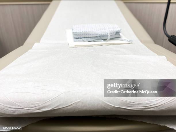 generic medical examination table & patient gown - examination table stock pictures, royalty-free photos & images