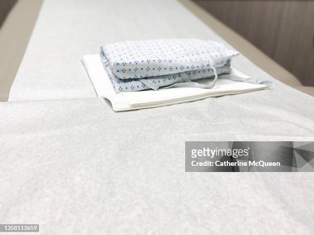 generic medical examination table & patient gown - examination gown stock pictures, royalty-free photos & images