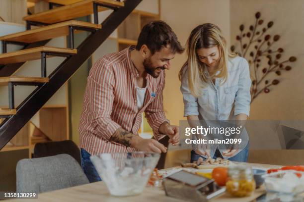 couple making pizza - pizza with ham stock pictures, royalty-free photos & images